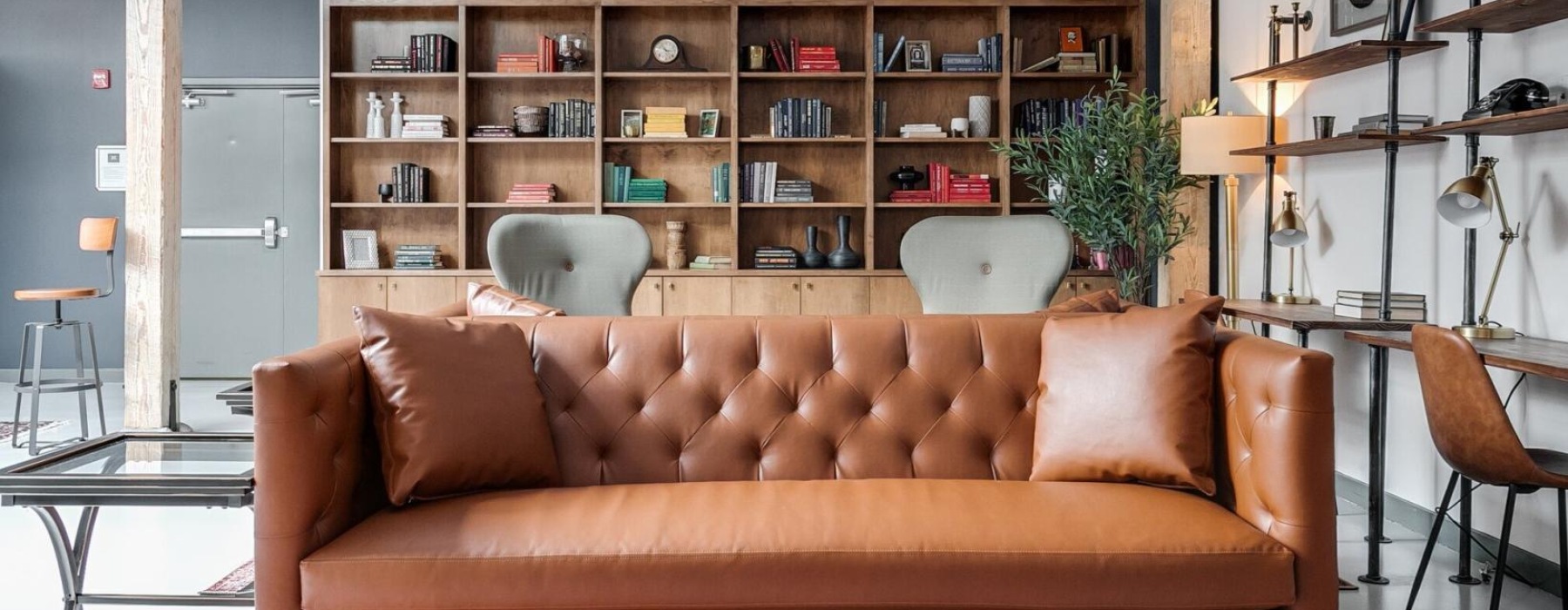 a couch in a room with shelving behind it